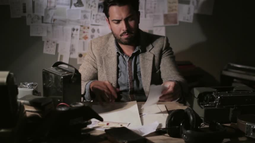 Man studying many notes in his office