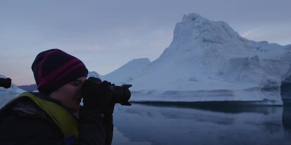 Person with binoculars at a cold seaside