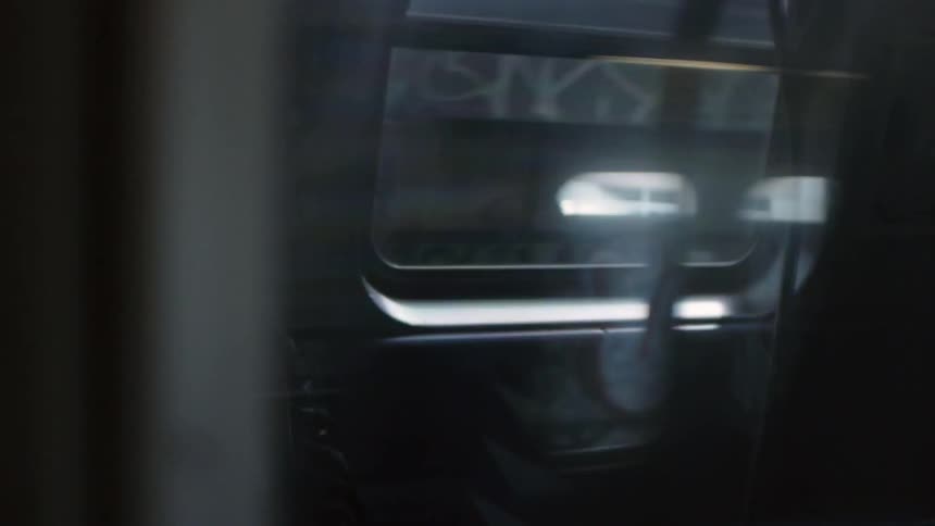 A train passes by parallel to another in the afternoon