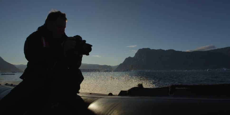 A man taking pictures on a boat