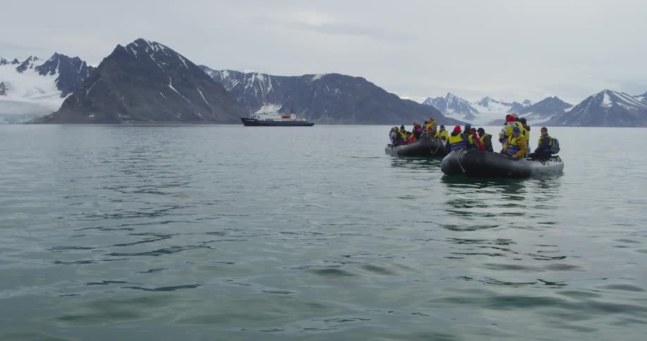 Rafts of people float on a mountain lake