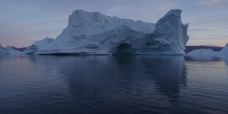 Giant iceberg floating in blue water