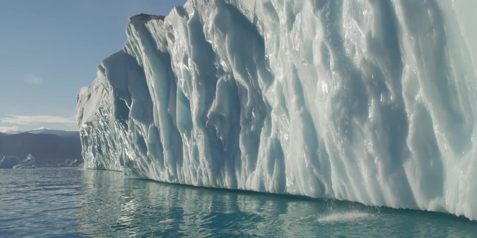Giant iceberg floating in blue water