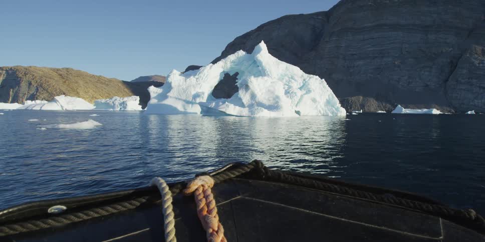 A boat heads towards a glacier