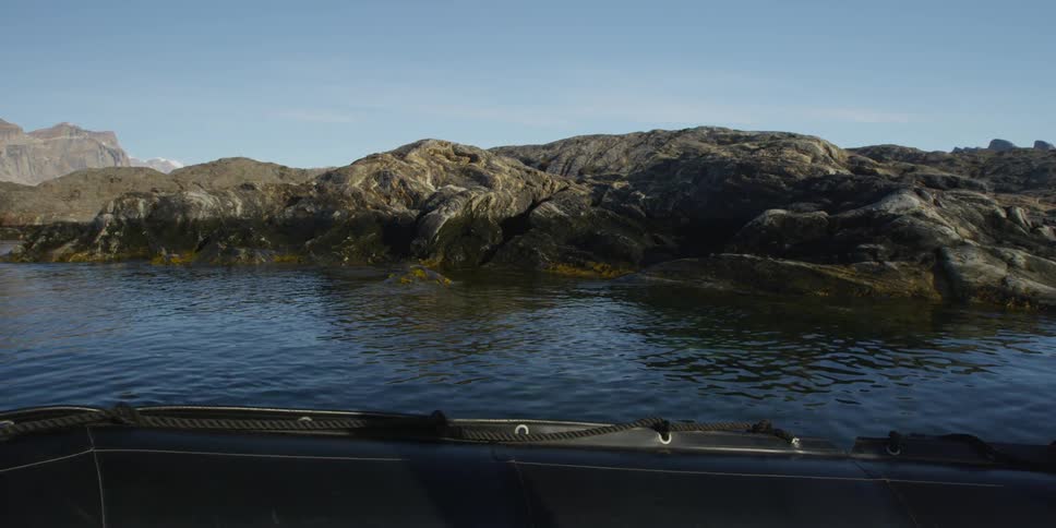 View of calm waters from a boat flowing along