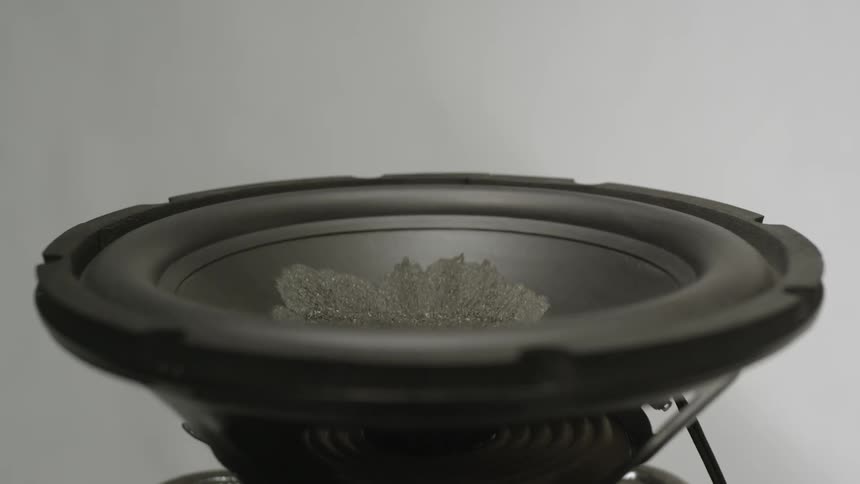 A speaker that is turned on and playing audio