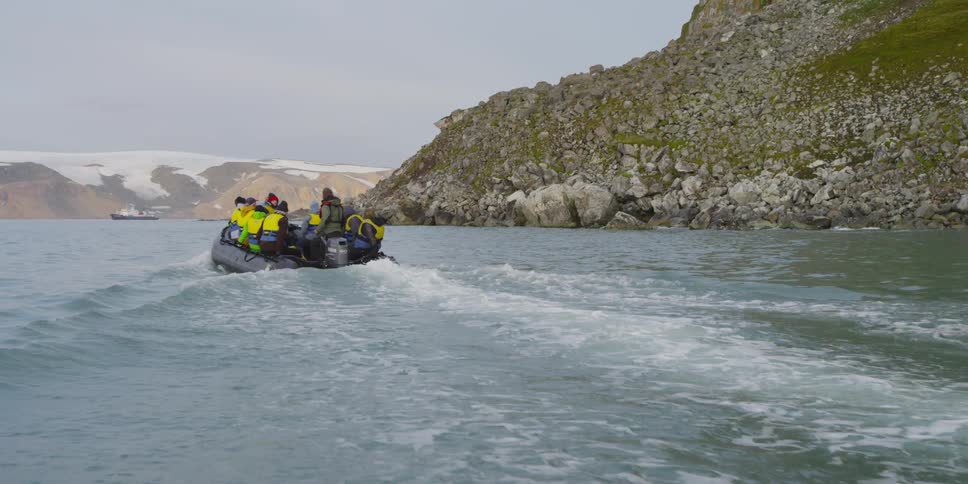 People ride on an inflatable boat