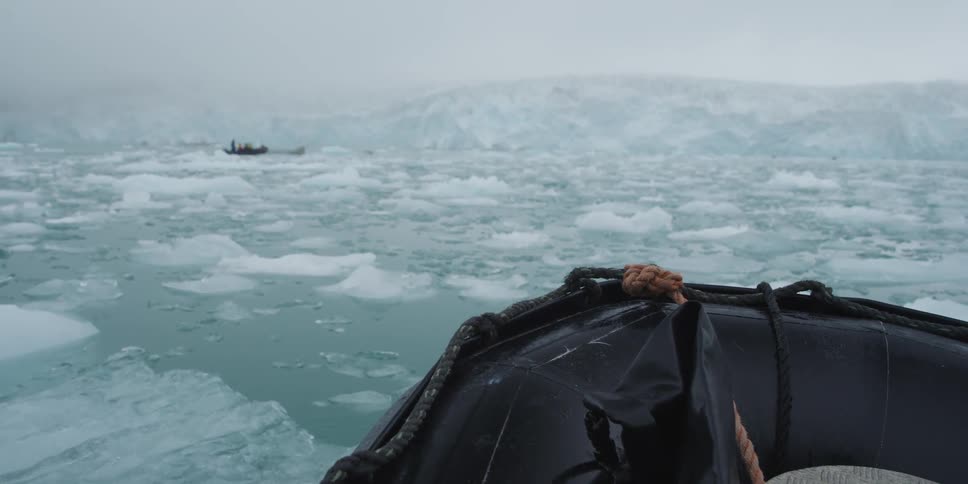 A boat floats through frozen water