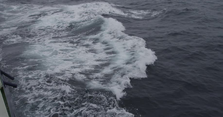 Waves from a boat's motion mix with the waves of the ocean