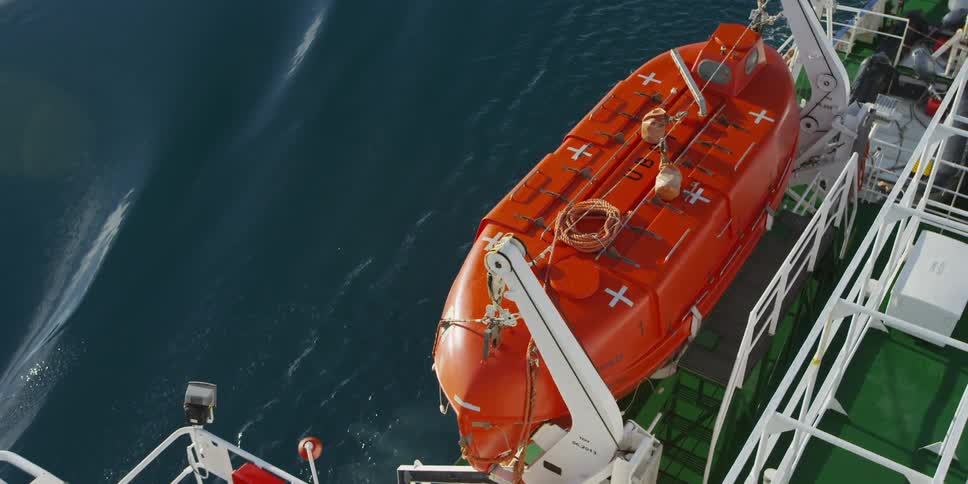 A lifeboat on the side of a large boat