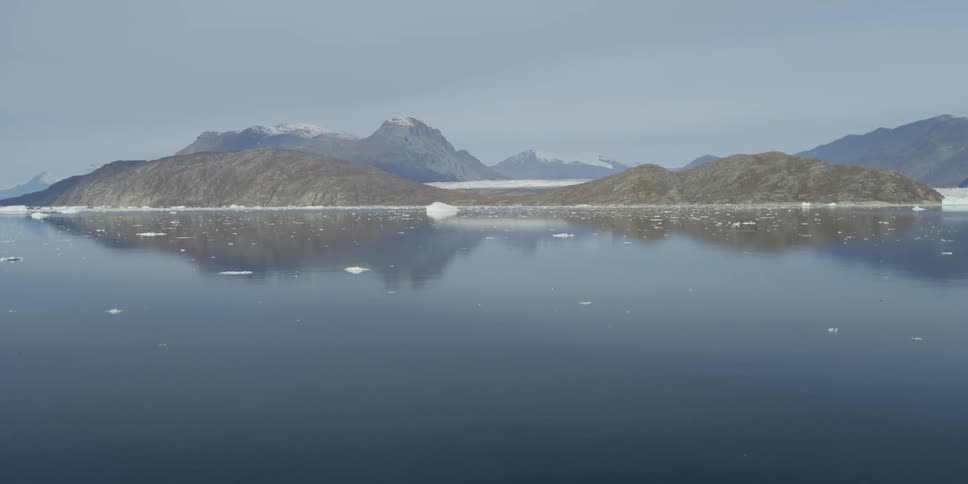 Mountains loom over a calm lake