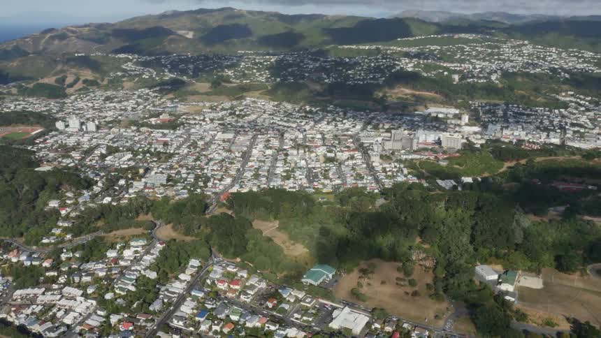 A drone glides over a quaint town
