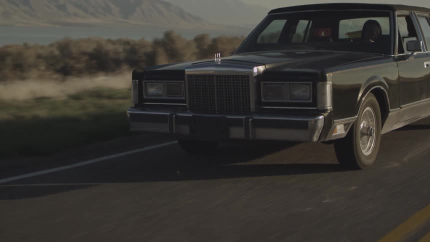 A car drives down a road
