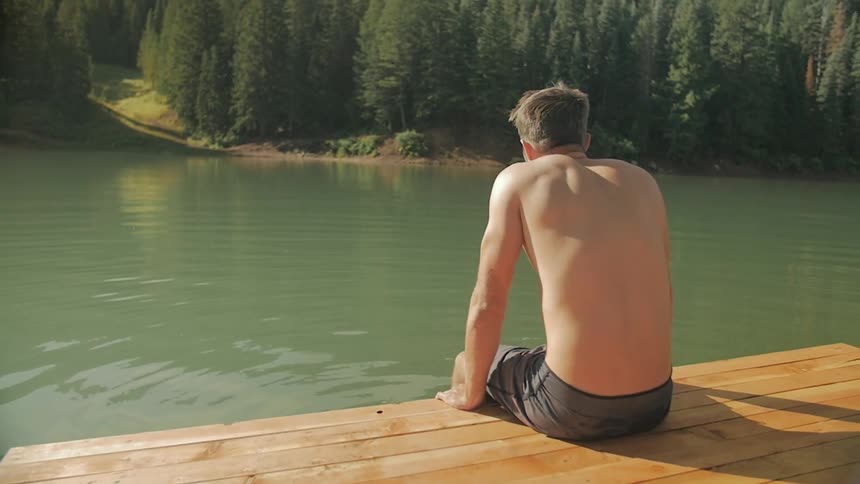 The man sits on the dock