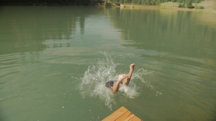 A man jumps into a lake