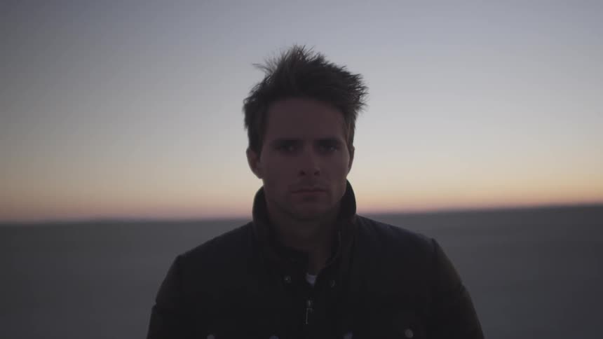 A man walks at dusk
