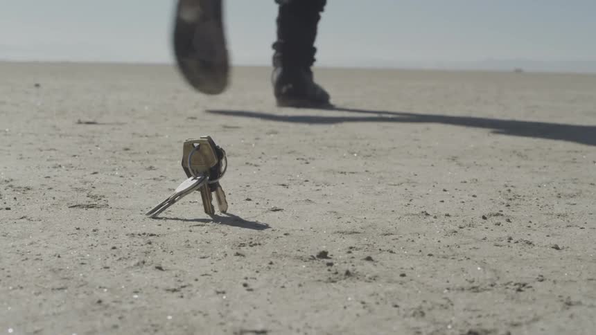 Keys drop while the person keeps walking