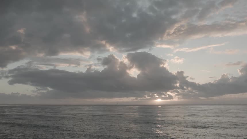 Sun begins to set over the ocean