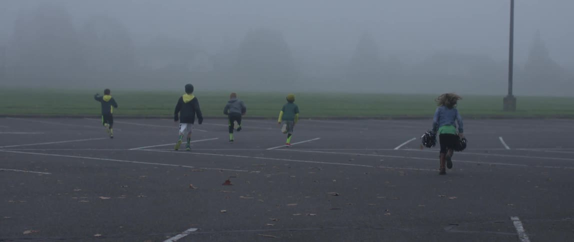 Children playing ball in a parking lot