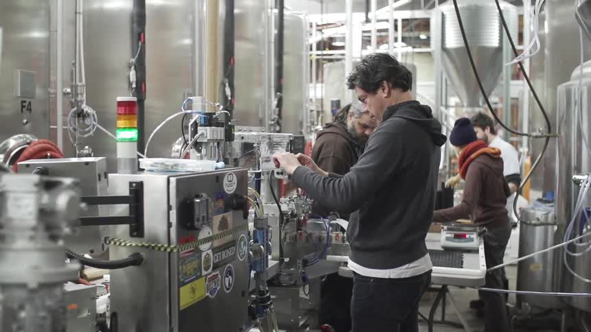 Workers in a factory operating machinery