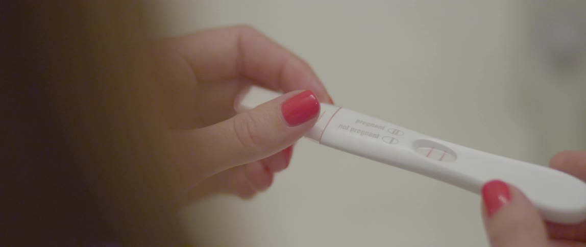 Hands holding a pregnancy test