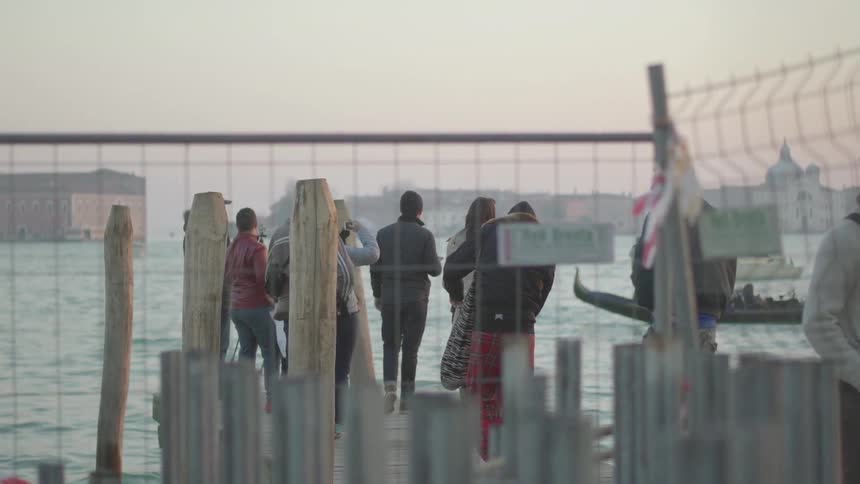 People stand on a pier in the winter