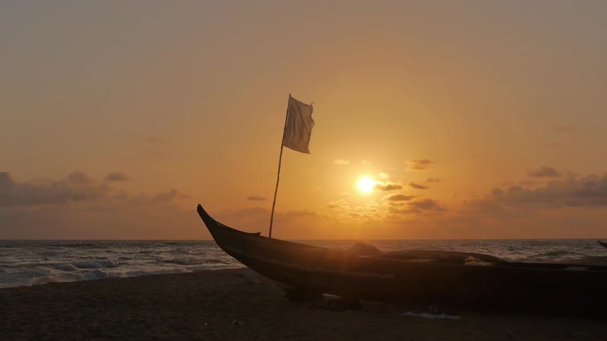 A flag mounted on a boat billows in the wind