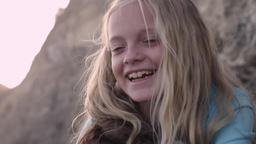 A girl smiles and laughs