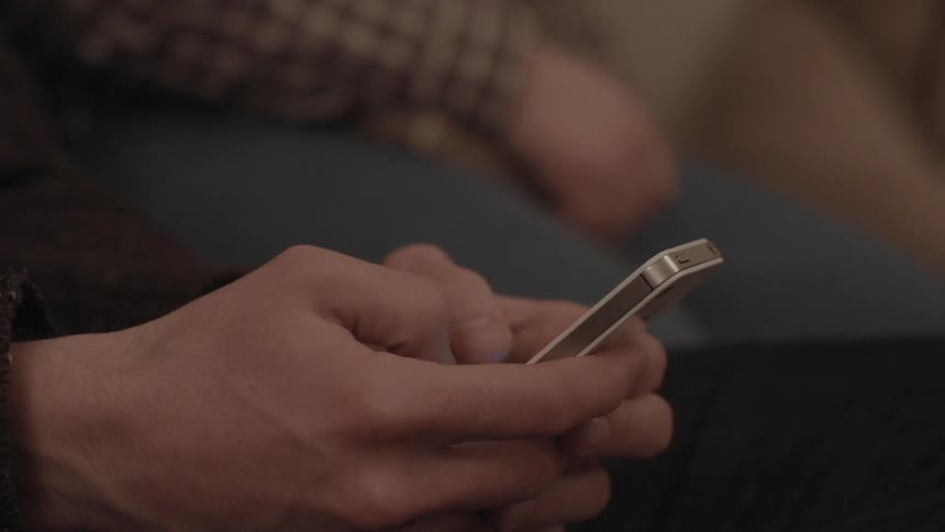 Person typing on their phone with their thumbs