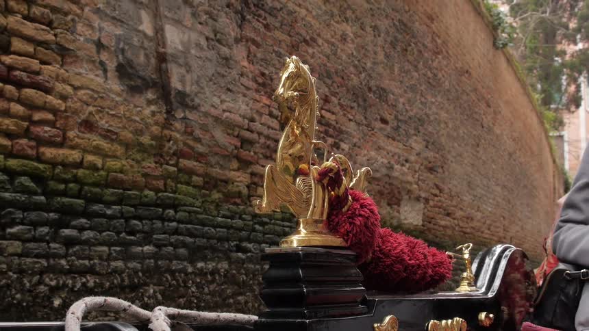 A close up of a golden horse on a boat