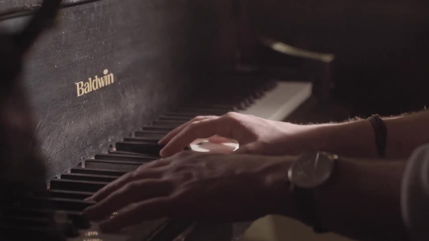 Man with watch plays piano