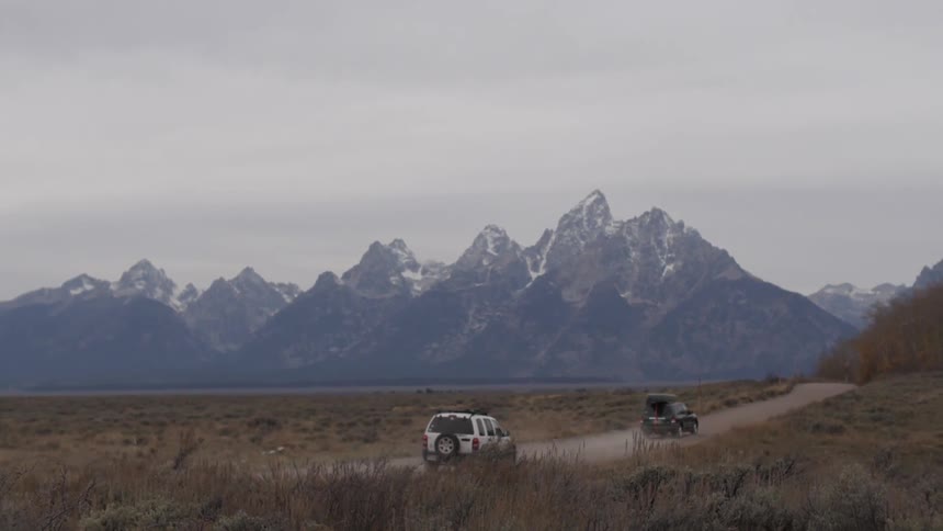 Cars travel toward a mountain