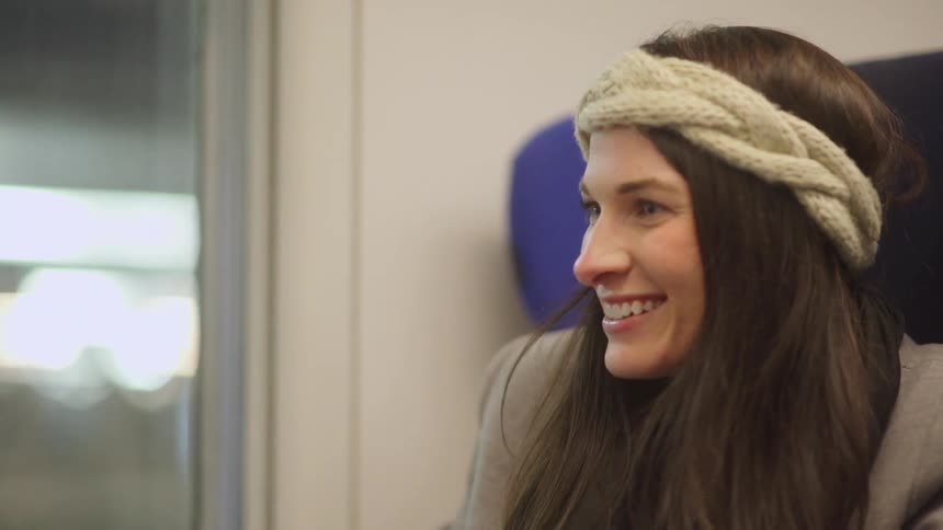 Woman laughing as she sits and talks