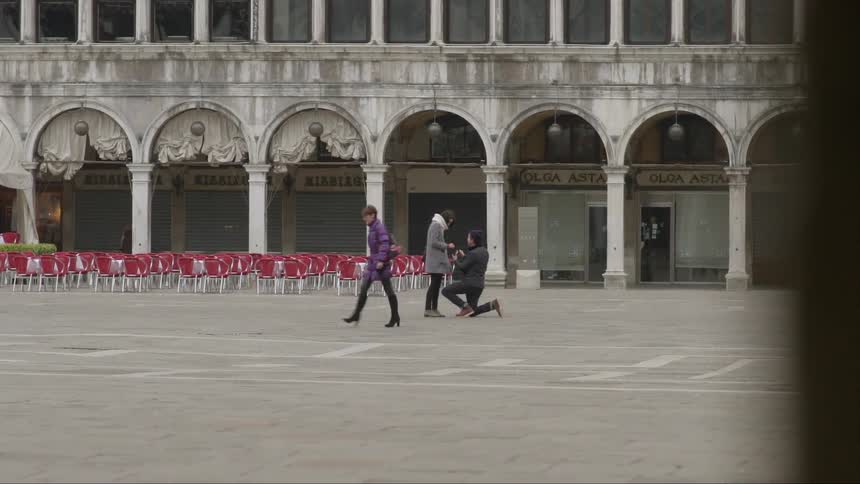 A man proposes to a woman in an urban area