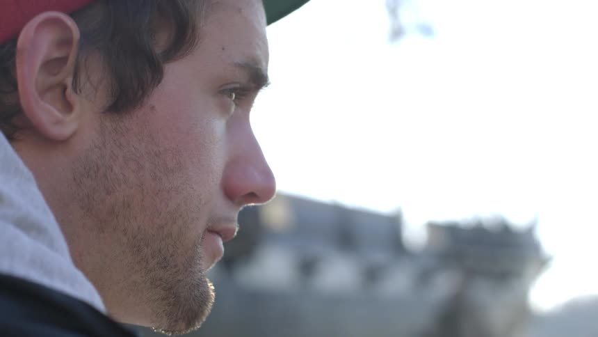 Man staring forward on a cloudy day