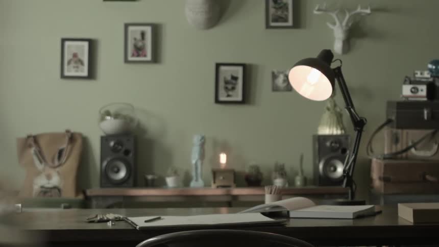 A desk lamp is lit in an office