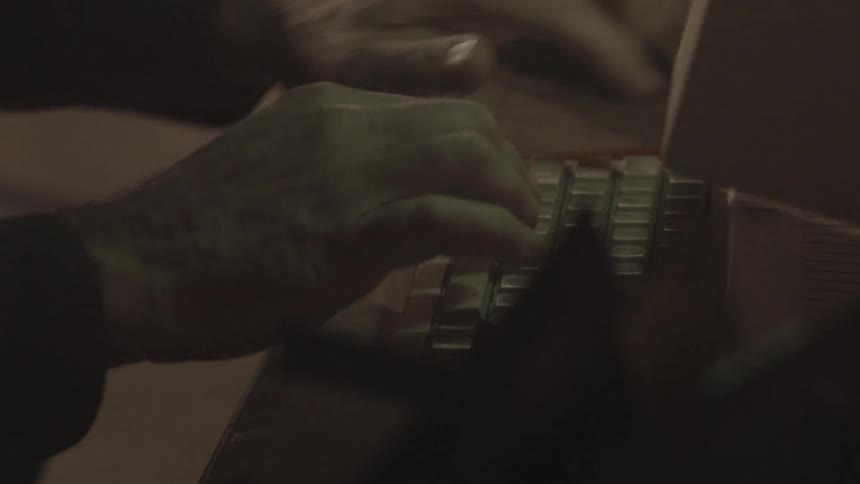 A man typing on old computer keyboard