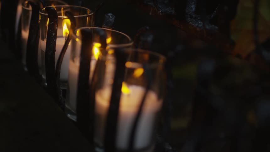 A row of candles burn