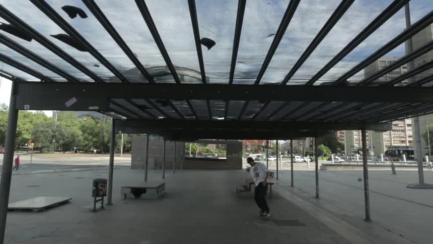 A young boy grinding on a small platform in an empty terminal