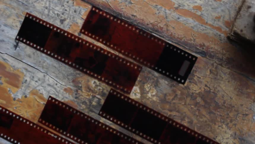 A close up view of film negatives on a workbench