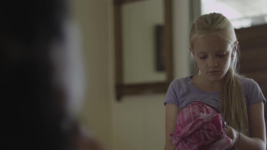 A girl given a present which she opens