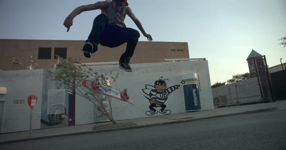 Man riding a skateboard during the day and doing tricks