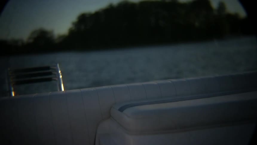 Man jumps off a boat diving into the water