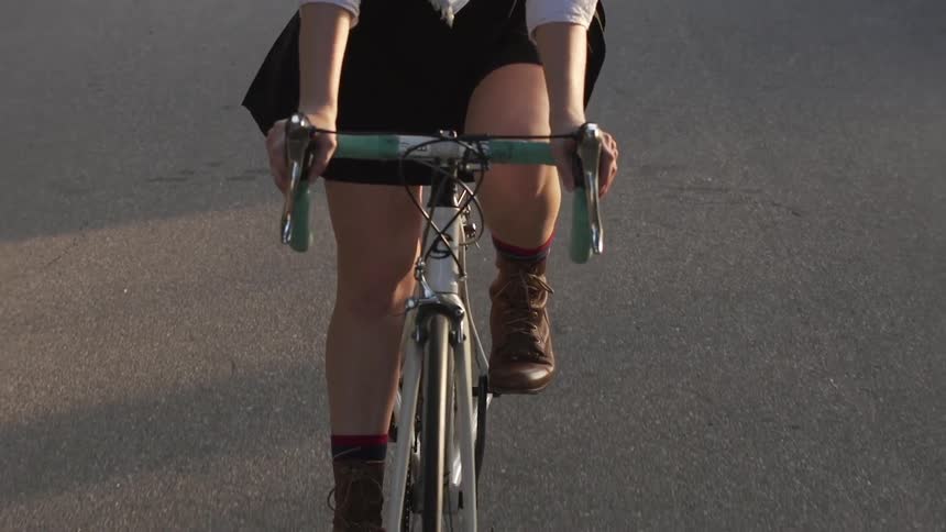 A person rides a bike on a street during the day
