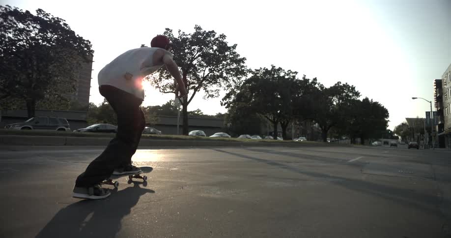 A skateboard rides down a road