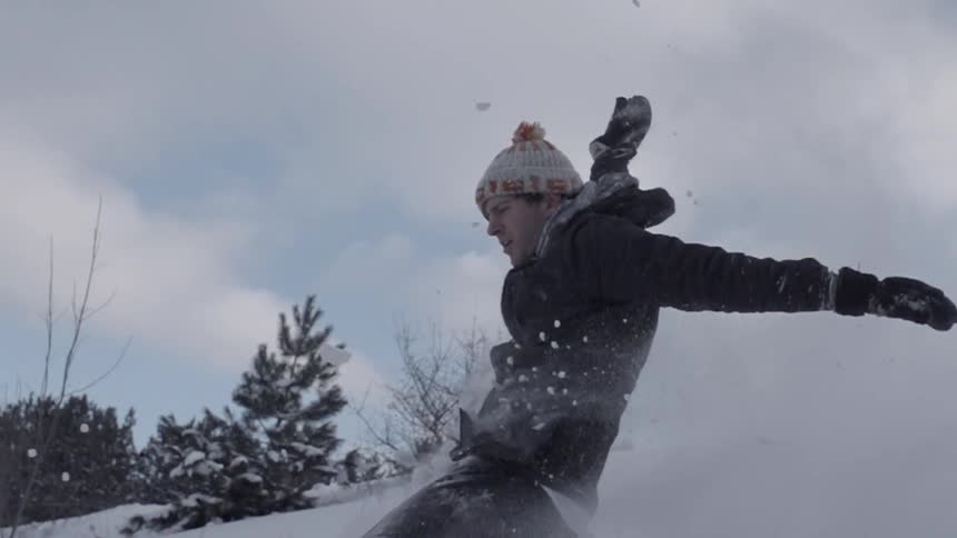 Man running around and jumping in the snow