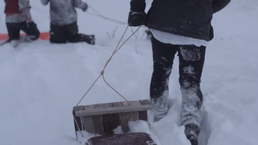 People pulls sleds through deep snow