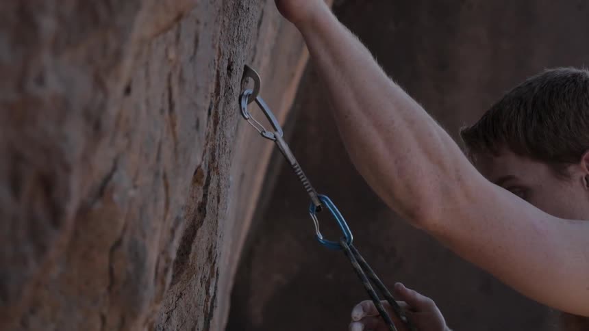 A man climbs up a rock