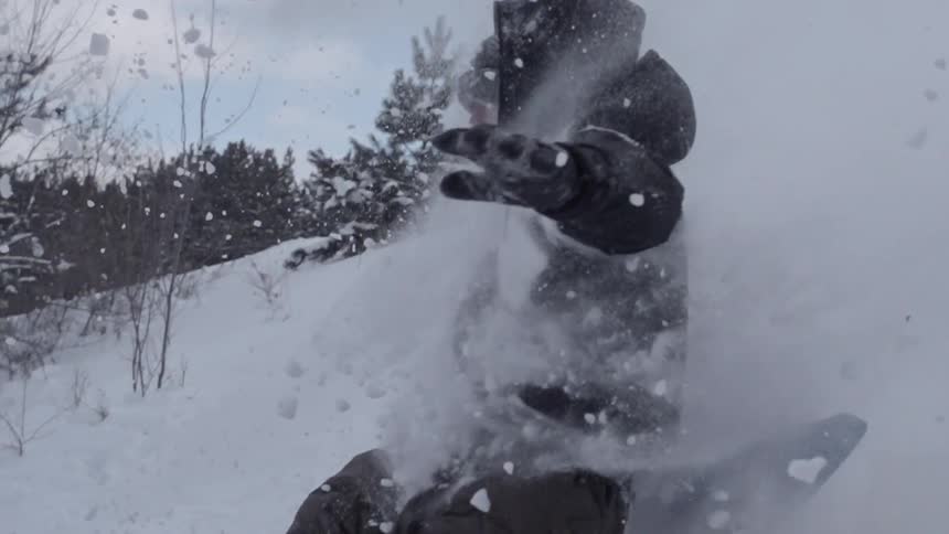 A person sleds down a snowy hill