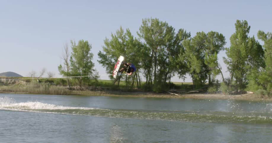 A man does a trick on a wakeboard
